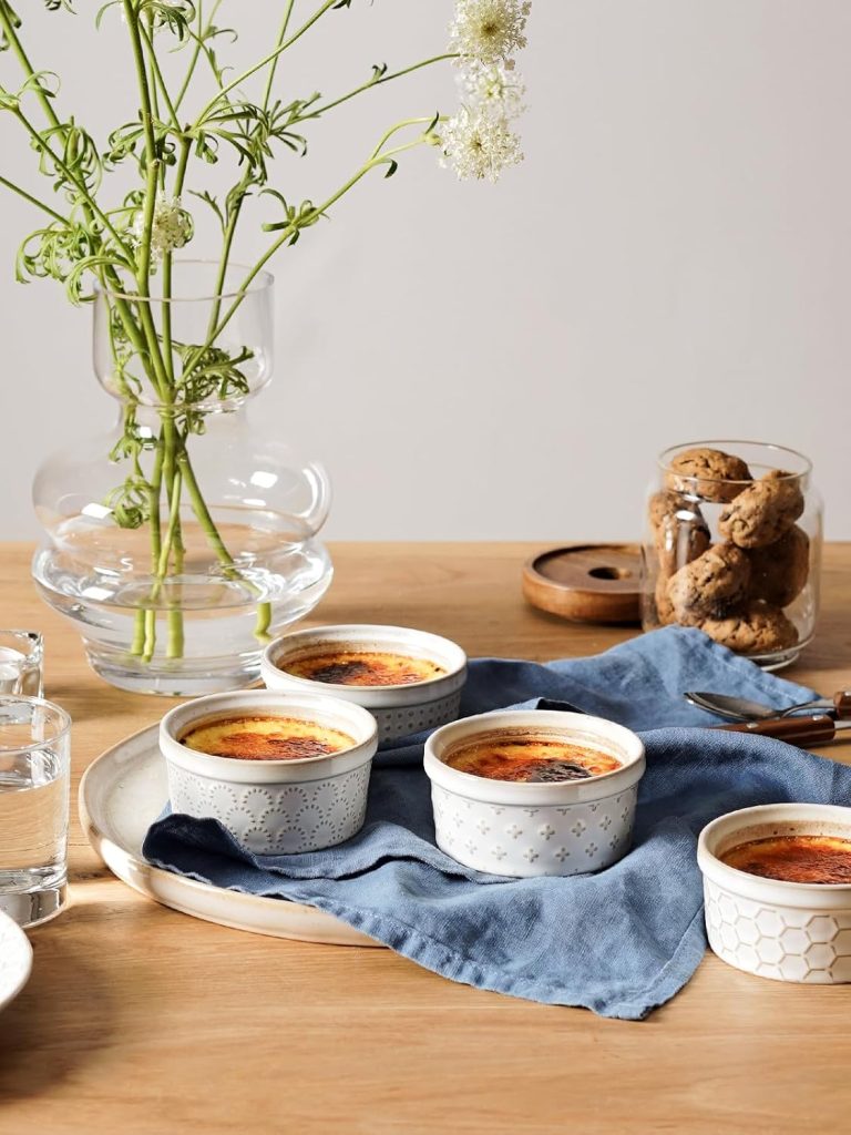 Best kitchen gift idea – elegant dessert serving setup with baked crème brûlée in ceramic ramekins on a wooden table.