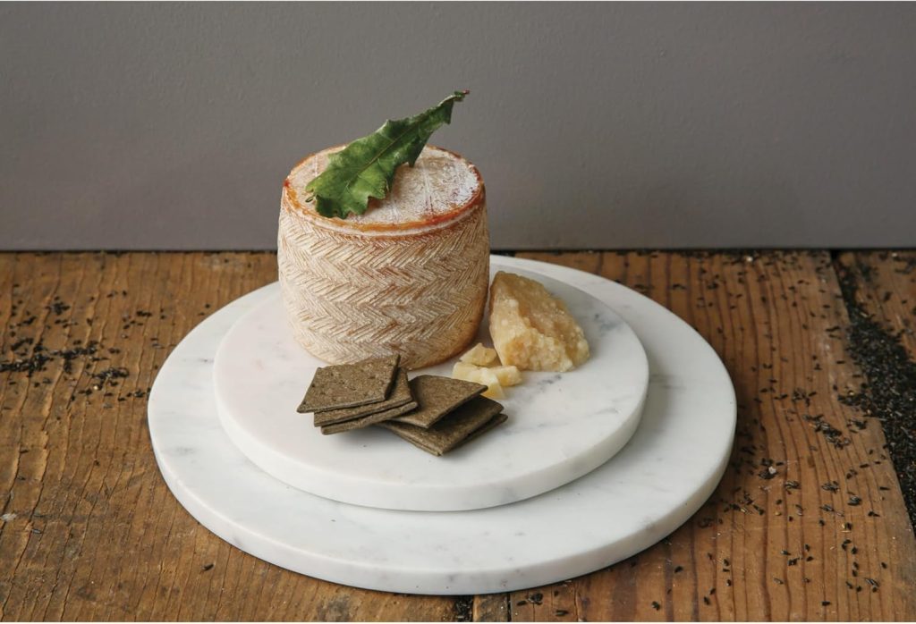 Best gourmet gift idea – artisan cheese served with crackers on a marble plate. 