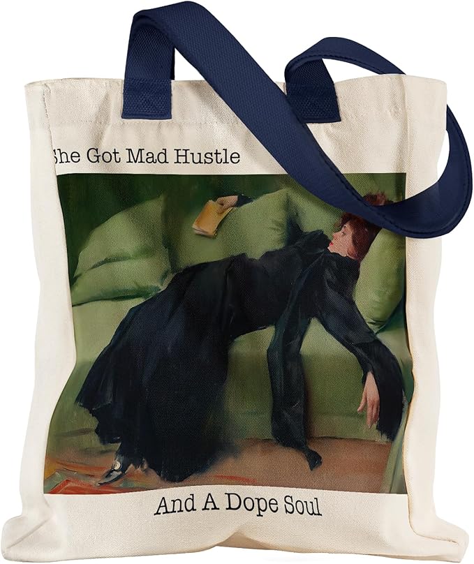 Canvas tote bag with navy handles featuring an artistic print and the quote “She Got Mad Hustle And A Dope Soul,” stylish everyday carry gift idea