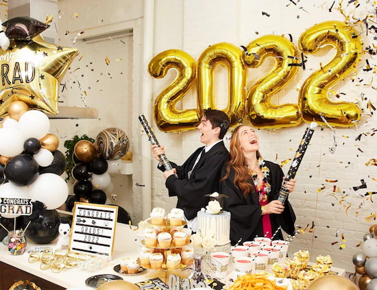 two students celebrating their graduation party